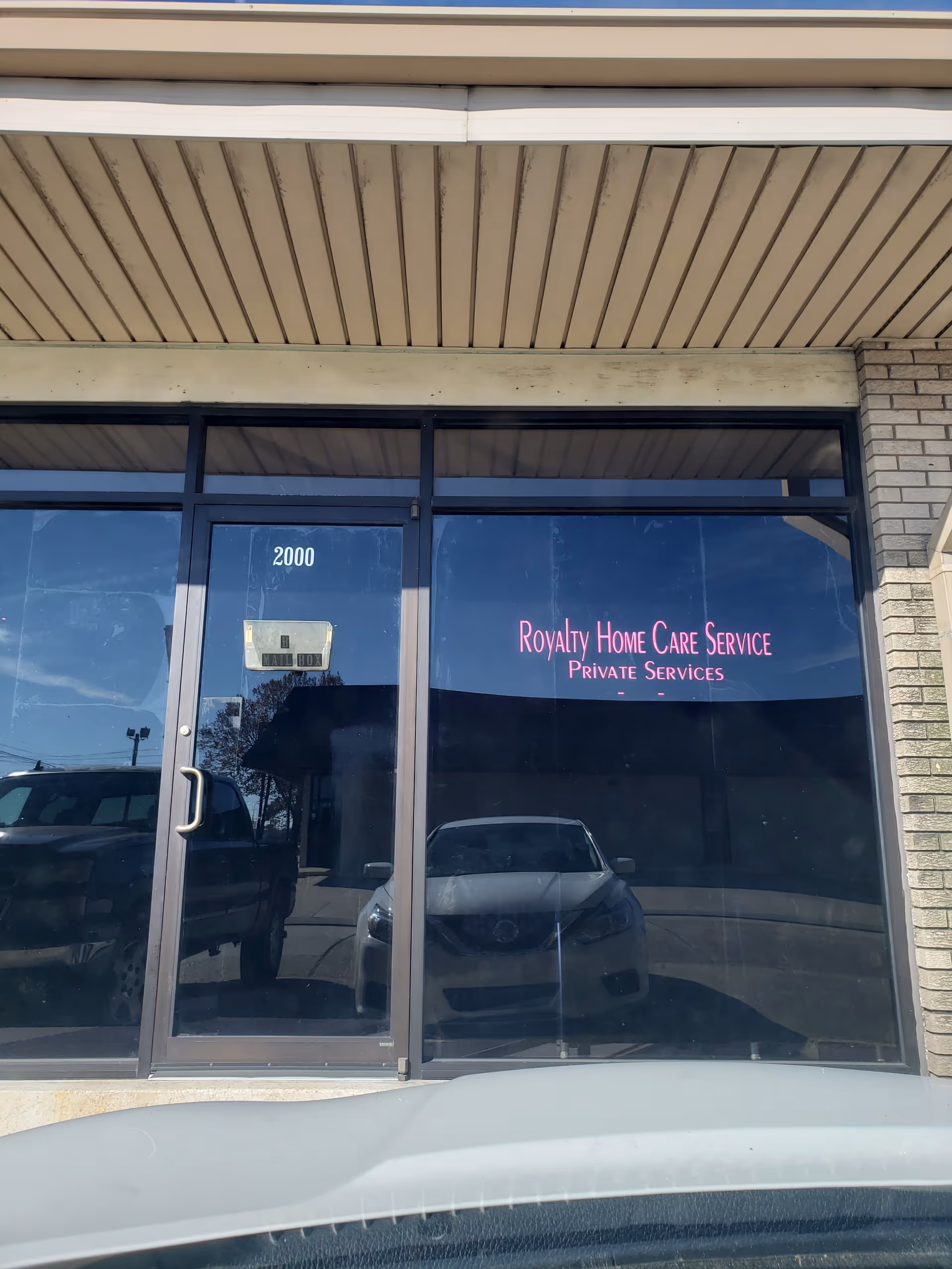Front view of a storefront with glass doors labeled Royalty Home Care Service.