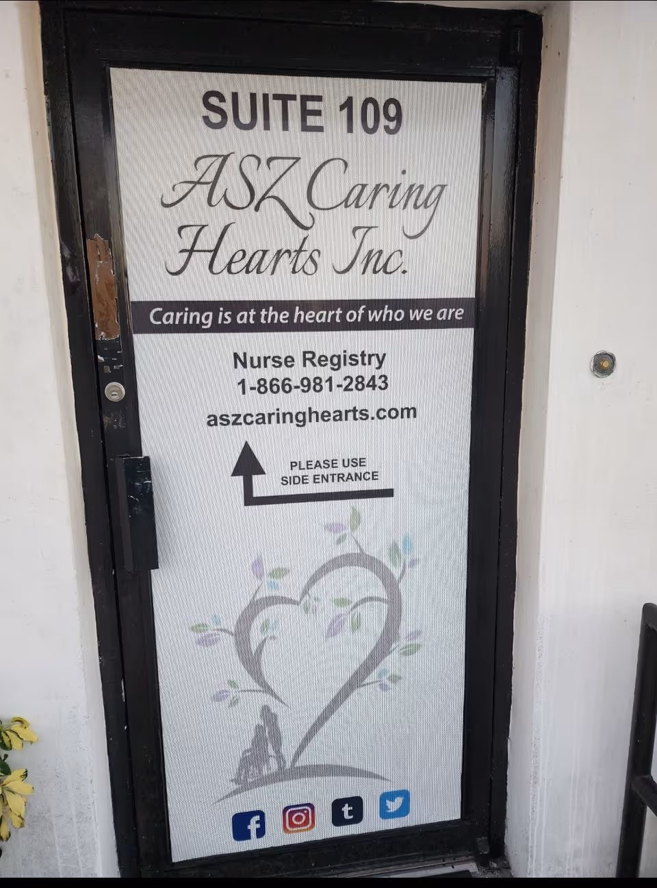 Front door sign for ASZ Caring Hearts Inc. with suite 109 and entrance directions.