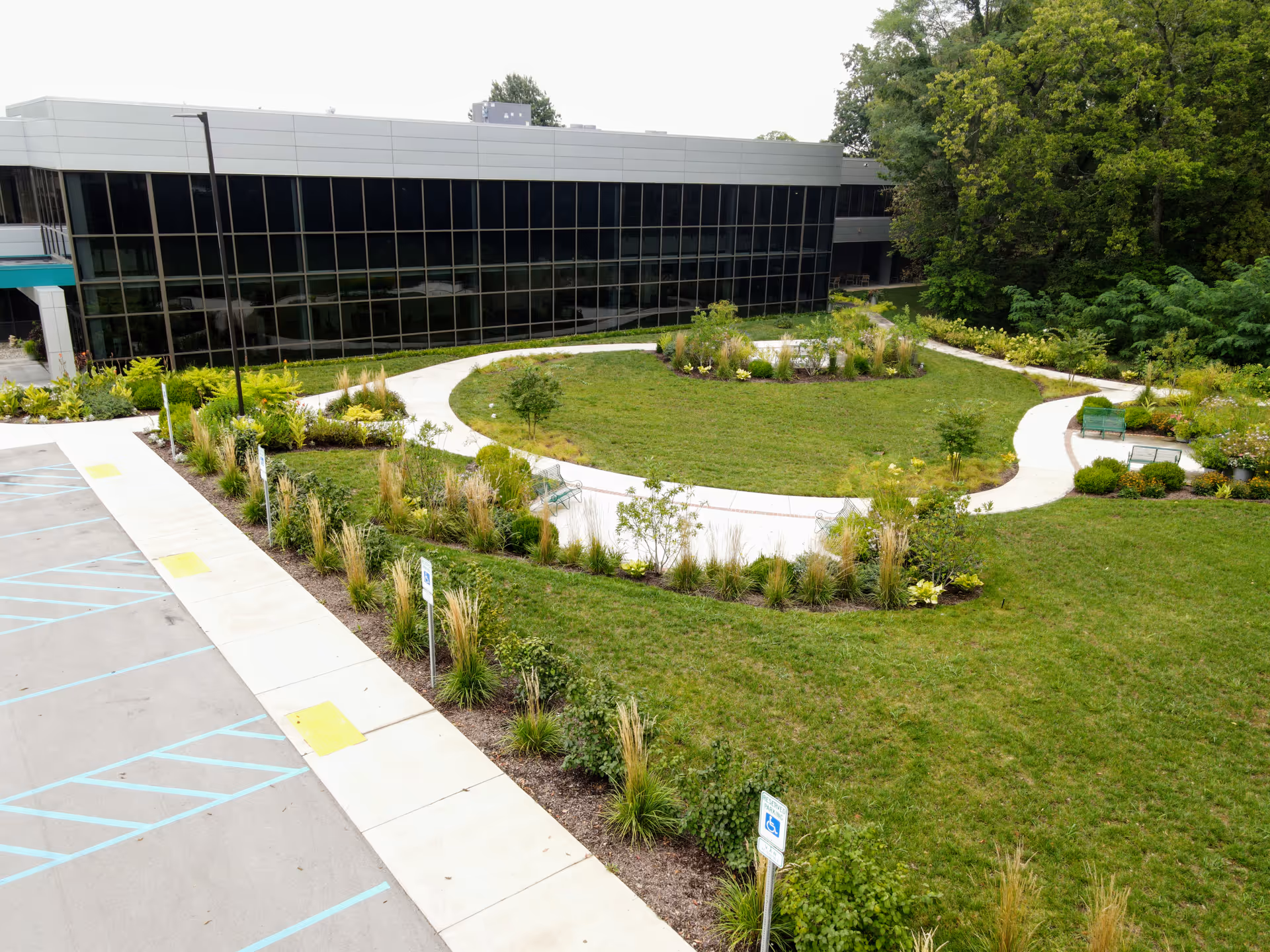 Exterior view of a modern building with a circular landscaped courtyard.