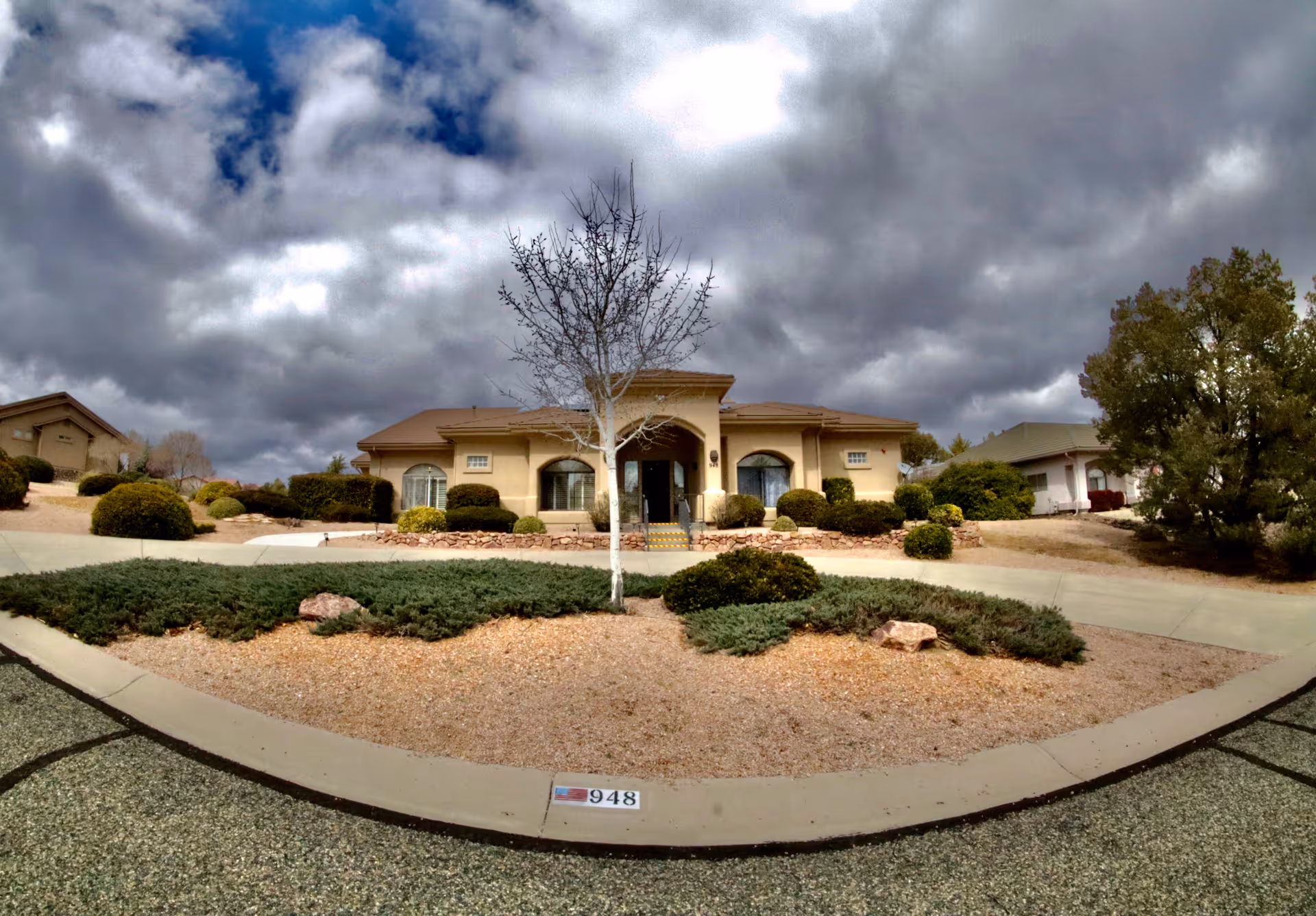 Front view of Wings of Faith Assisted Living building with landscaped entrance and curved driveway.