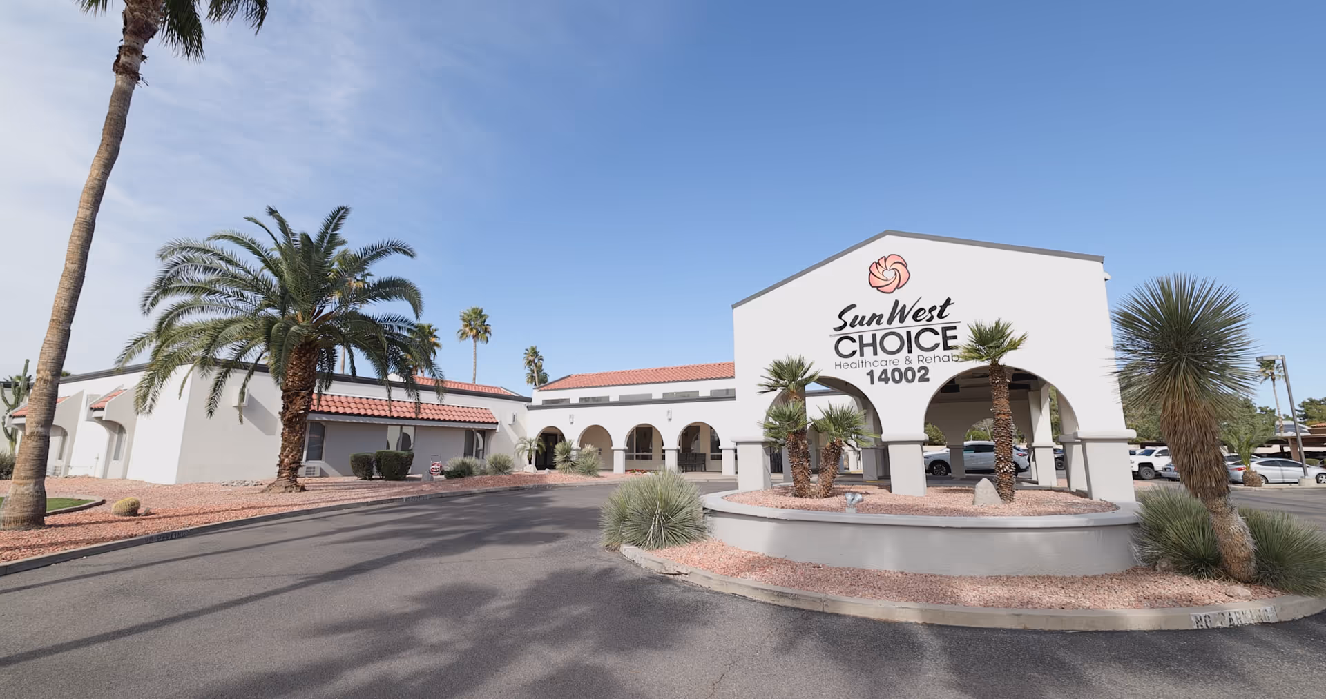Sun West Choice Healthcare and Rehab building exterior with palm trees and a circular entry drive.
