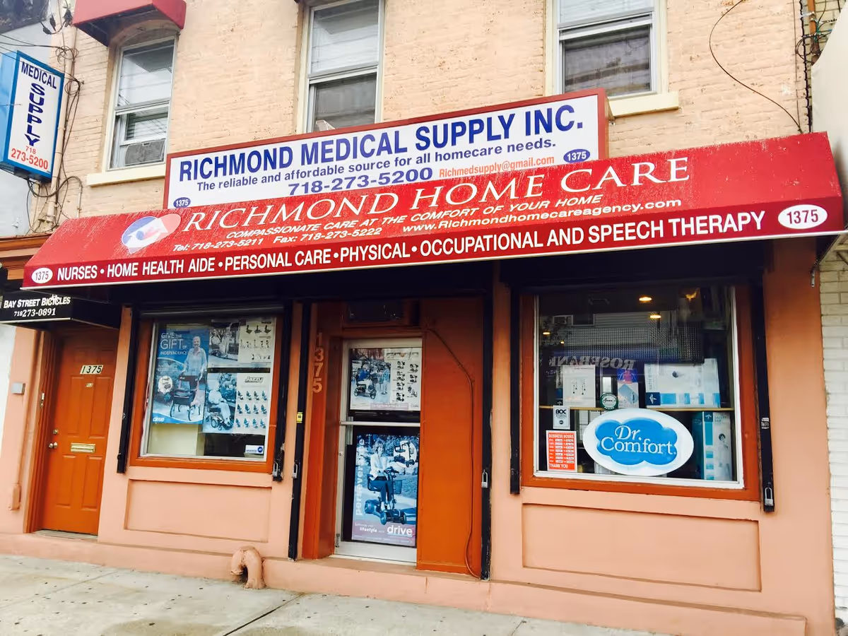 Exterior storefront for Richmond Home Care Agency with red awning and signs.