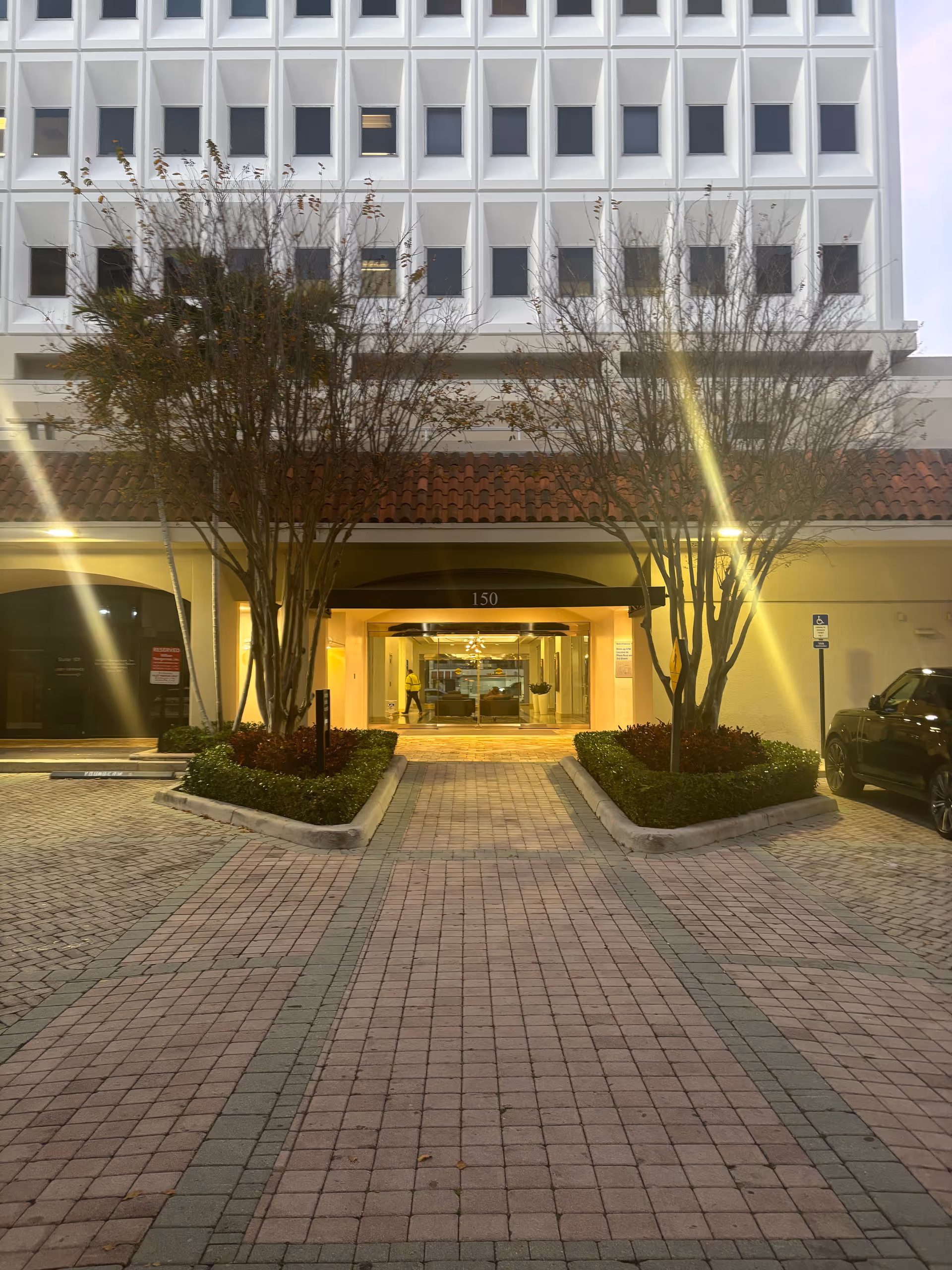 Entrance to Nicmoy Home Care Services, a senior living facility, with landscaped approach.