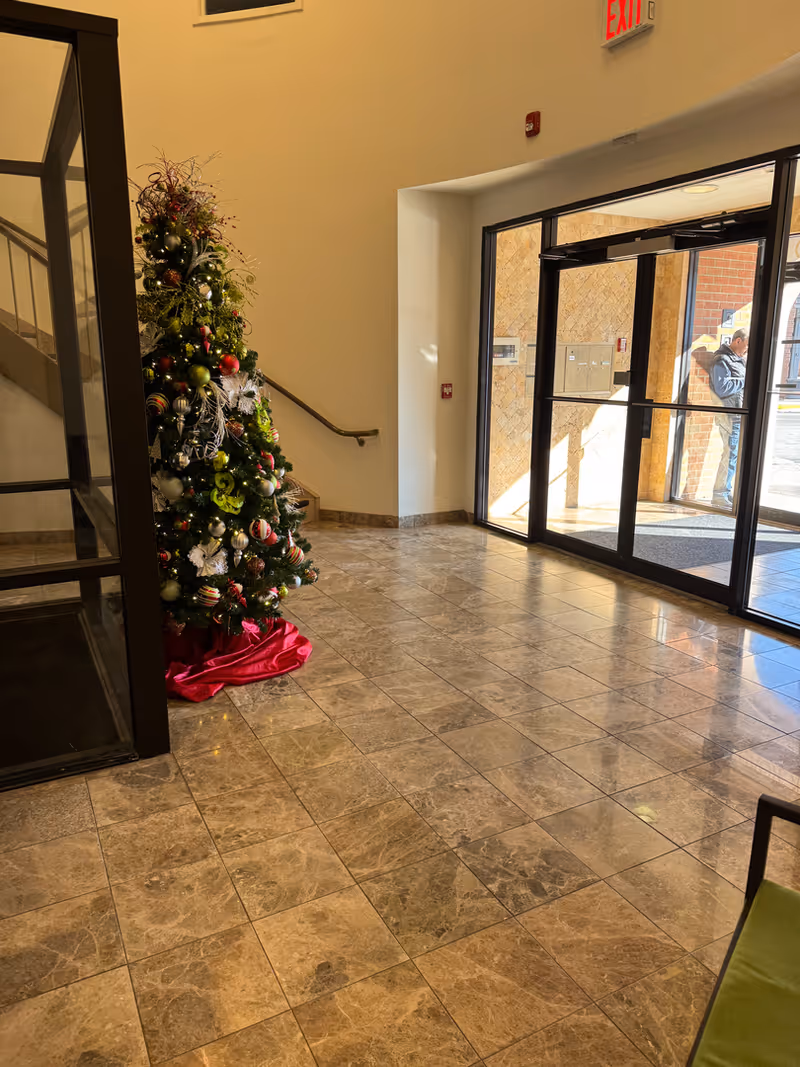 Interior lobby of FirstLight Home Care of Bergen County with a Christmas tree near entrance.