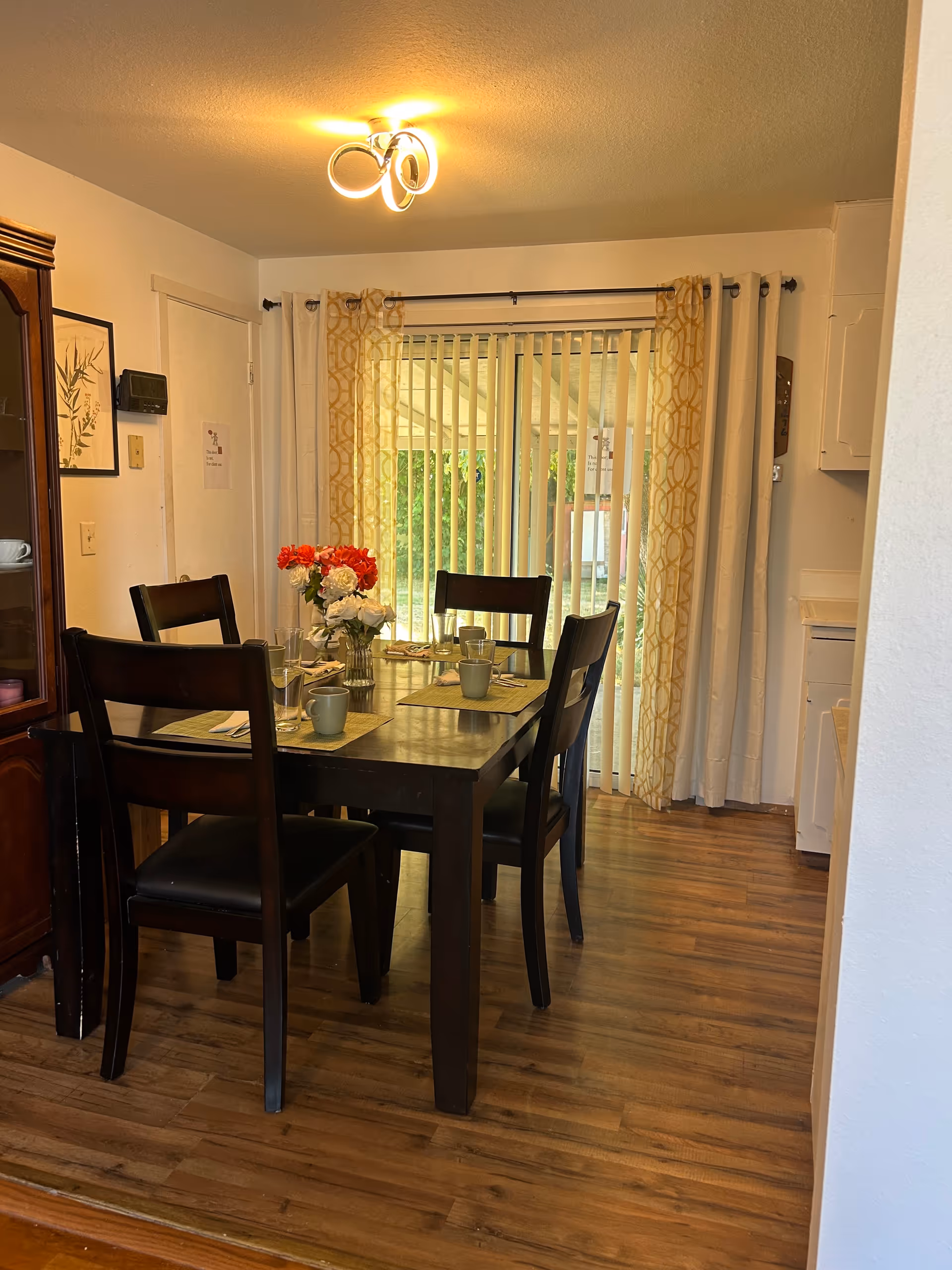 Dining table with six chairs and centerpiece in a cozy senior living dining room