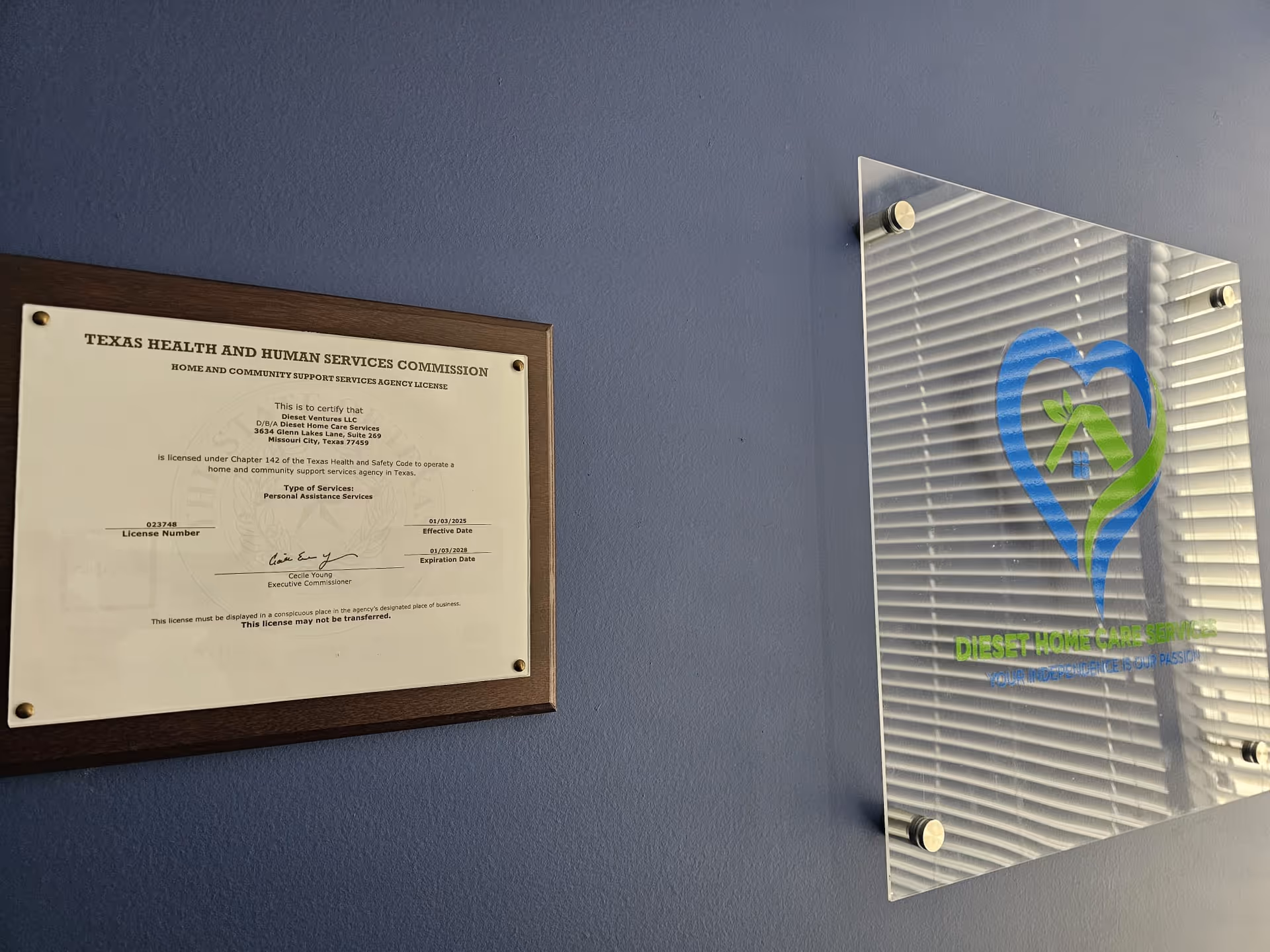 Blue wall shows a framed license and a glass plaque for Dieset Home Care Services.