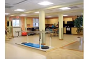 Interior rehabilitation gym at Apple Rehab Colchester with parallel bars and equipment