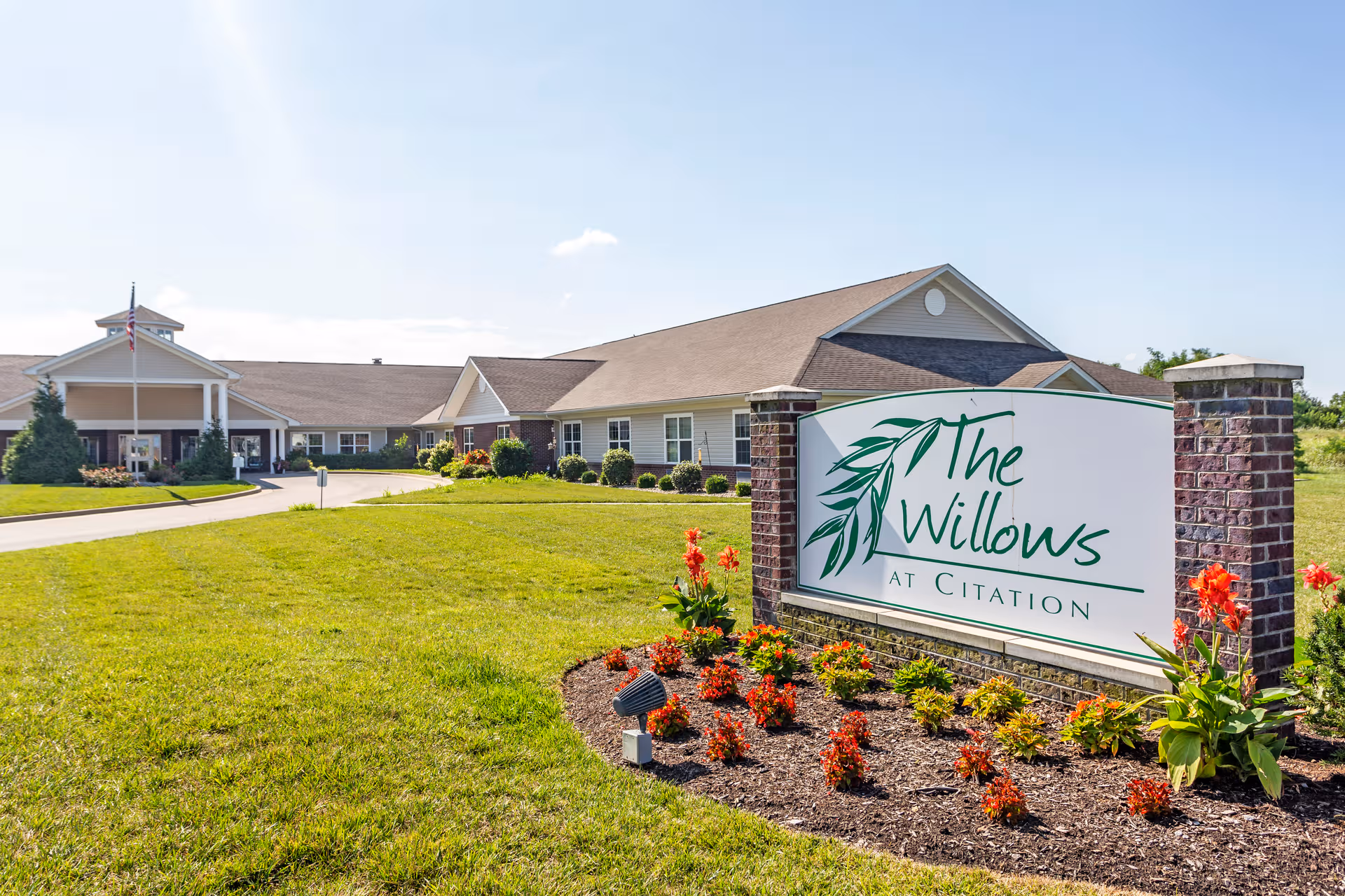 The Willows at Citation exterior with entrance sign and landscaped lawn.