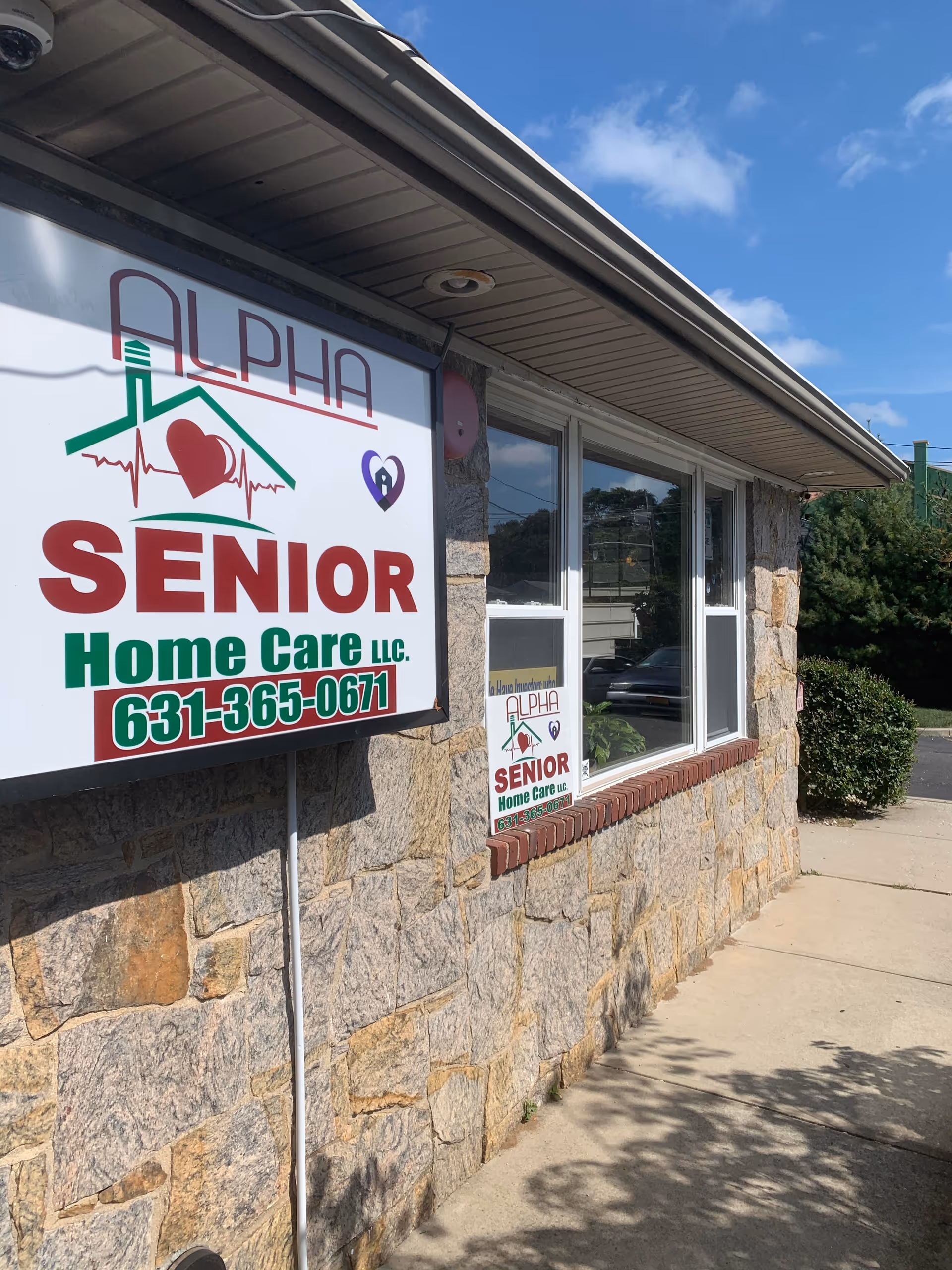 Stone building exterior with Alpha Senior Home Care sign and windows.