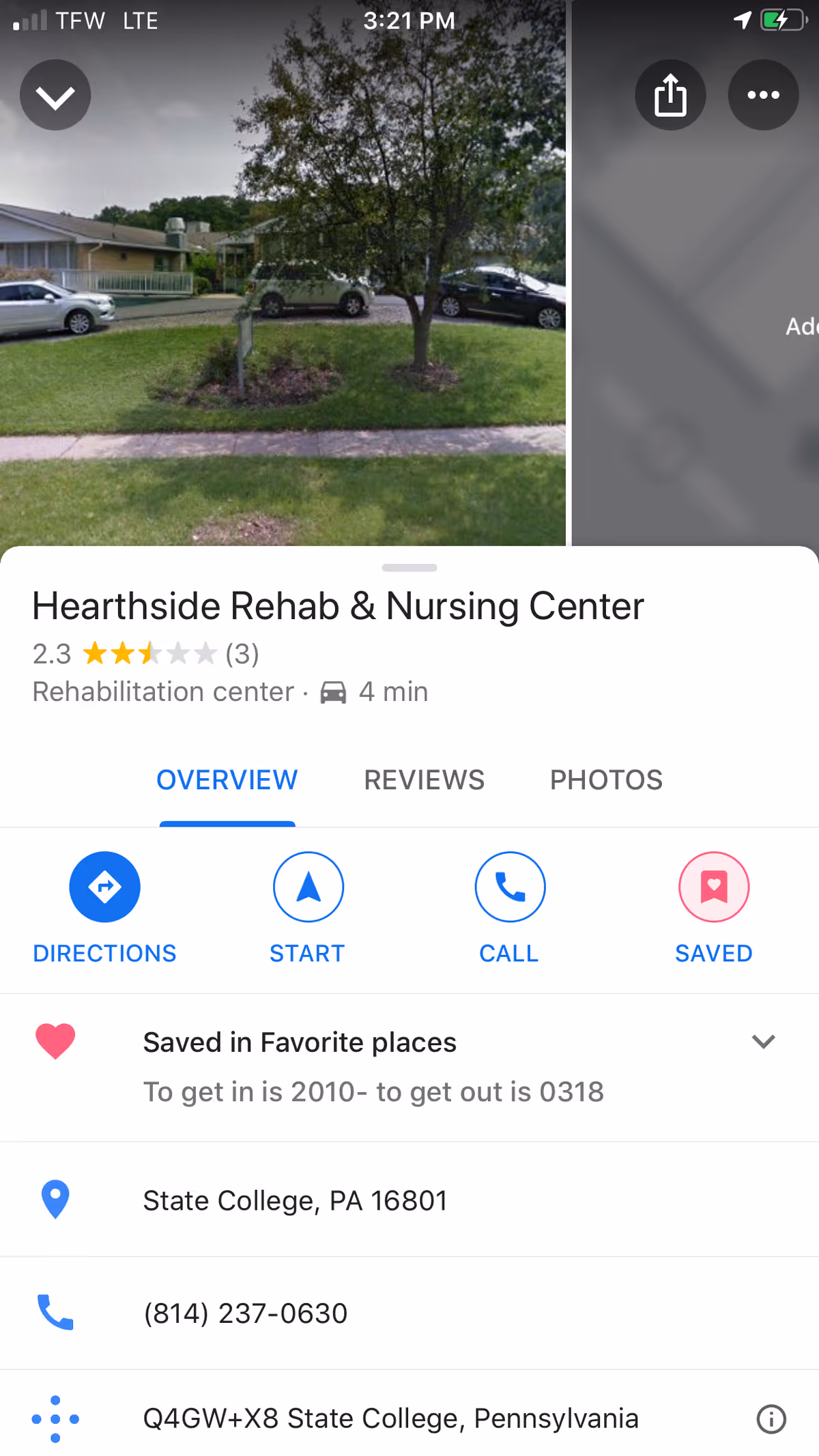Exterior view of Hearthside Rehab Center showing its front lawn and parked cars.