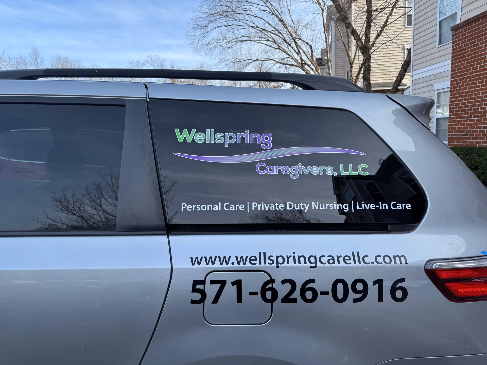 Side of a Wellspring Caregivers, LLC branded van outdoors