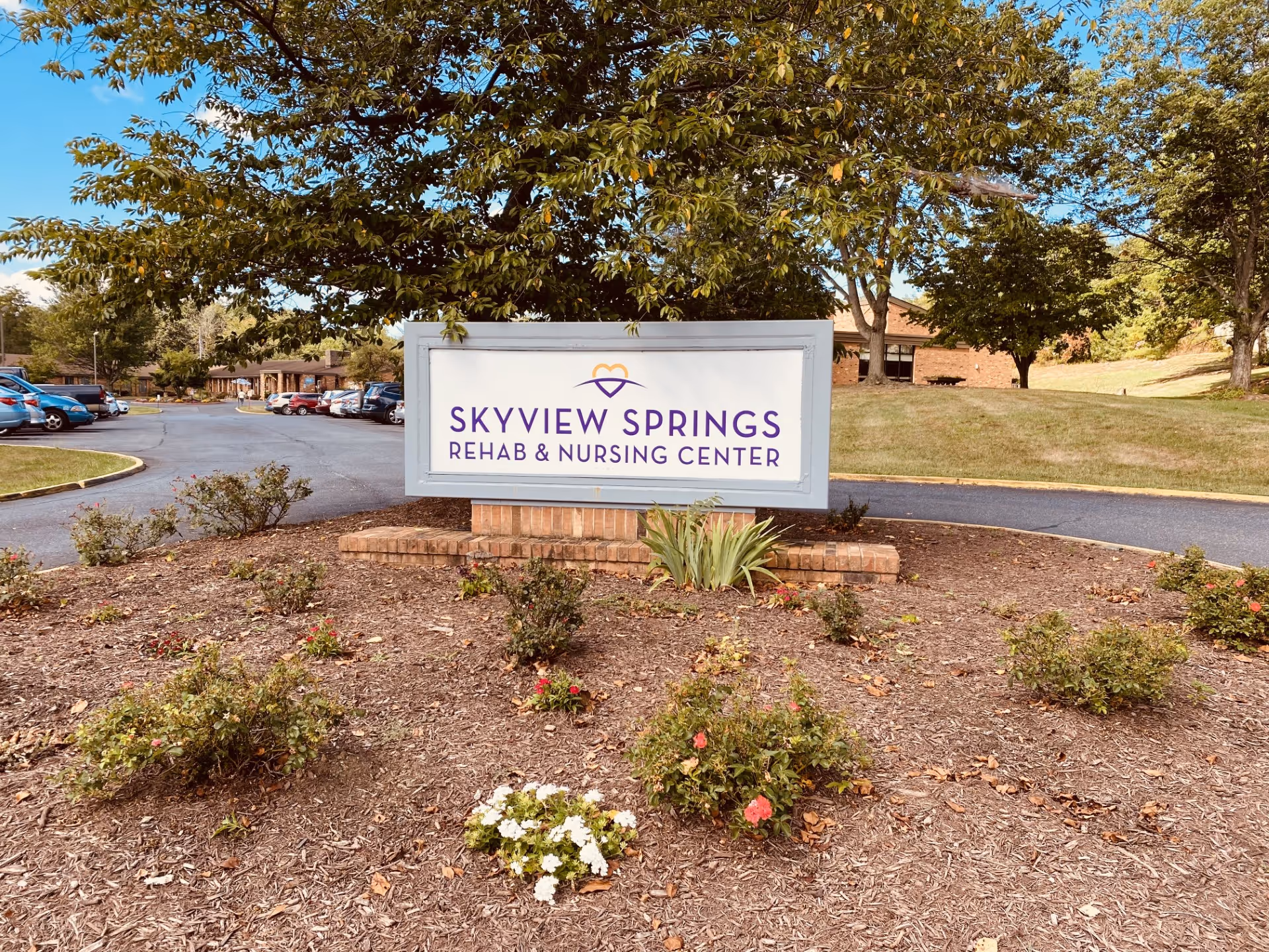 Sign for Skyview Springs Rehab & Nursing Center in front yard landscaping.