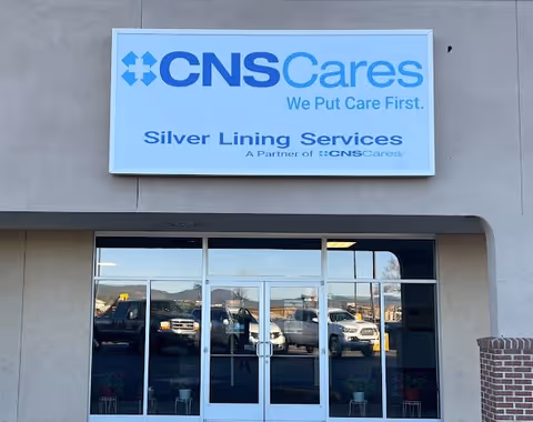 Exterior view of Silver Lining Services facility entrance with CNSCares sign.