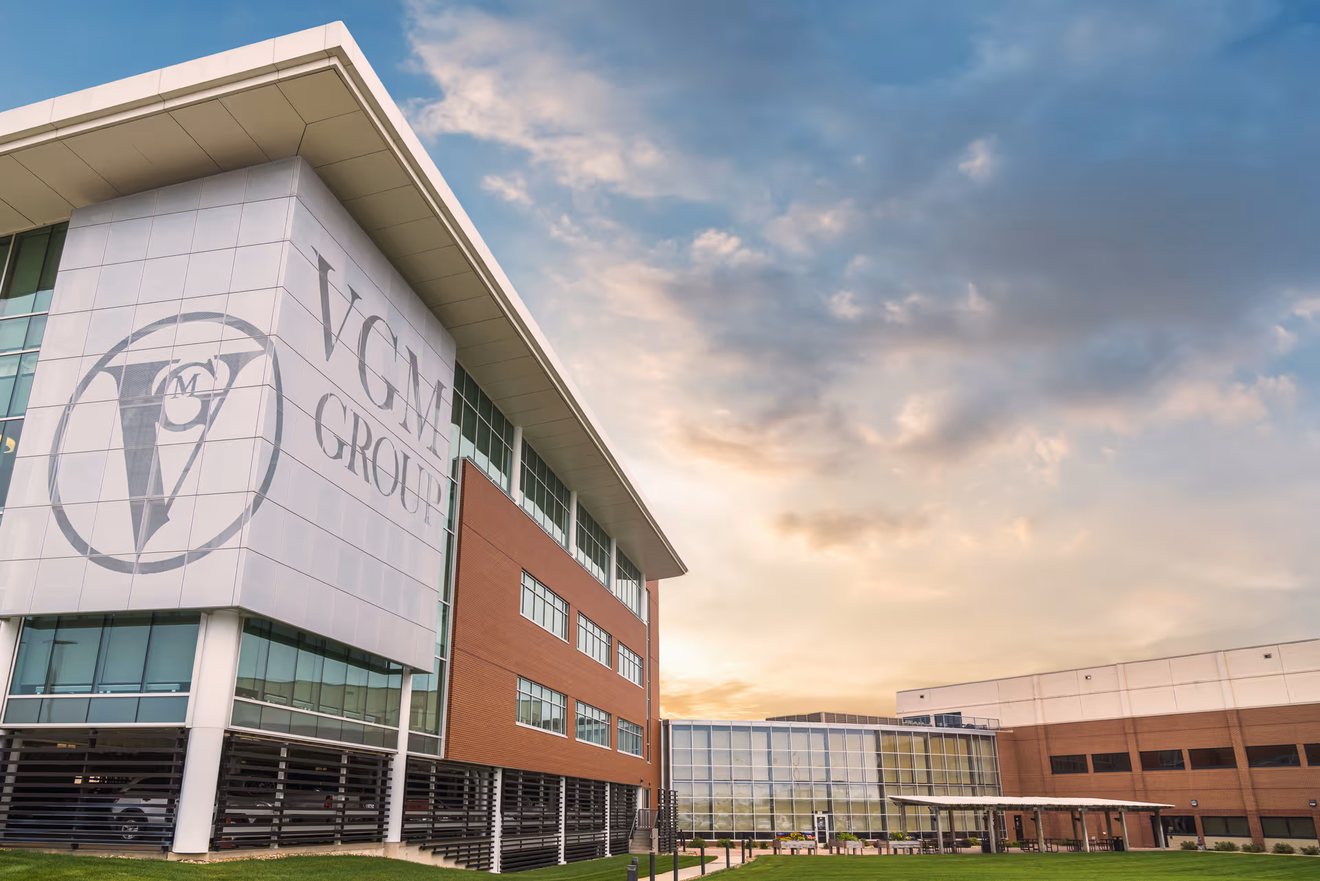 Front exterior of a modern building with a large logo and glass windows.