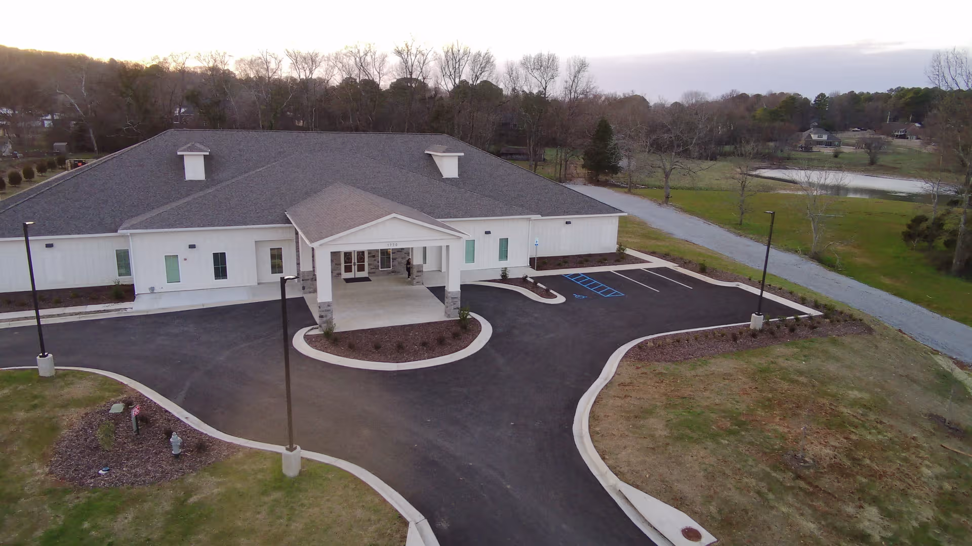 Aerial view of a large senior living facility with circular driveway and front entrance.