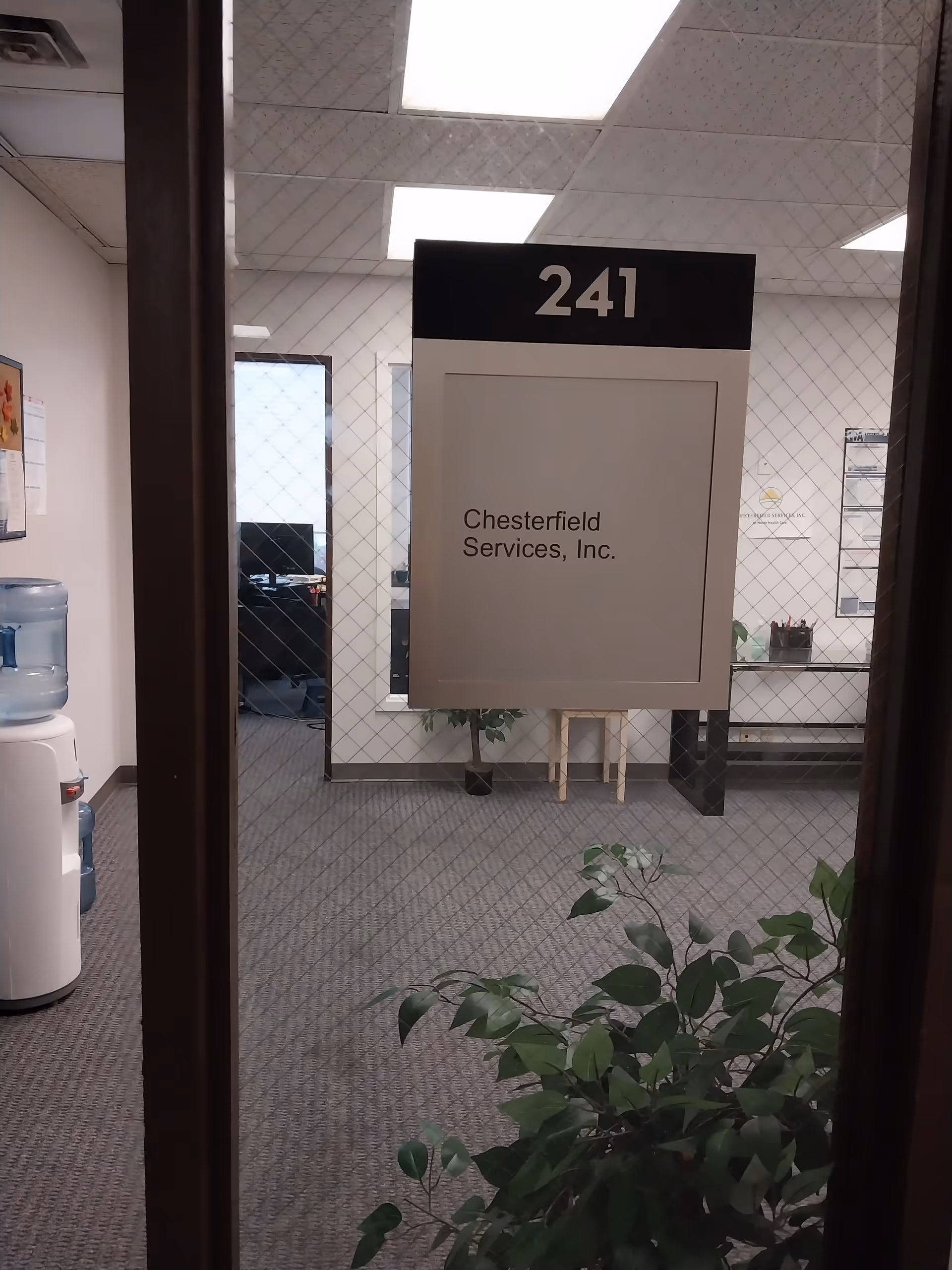 Interior office hallway view with a door sign reading Chesterfield Services, Inc. and number 241.