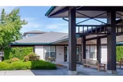 Exterior view of Linden Grove Health Care Center with covered entrance and landscaping.