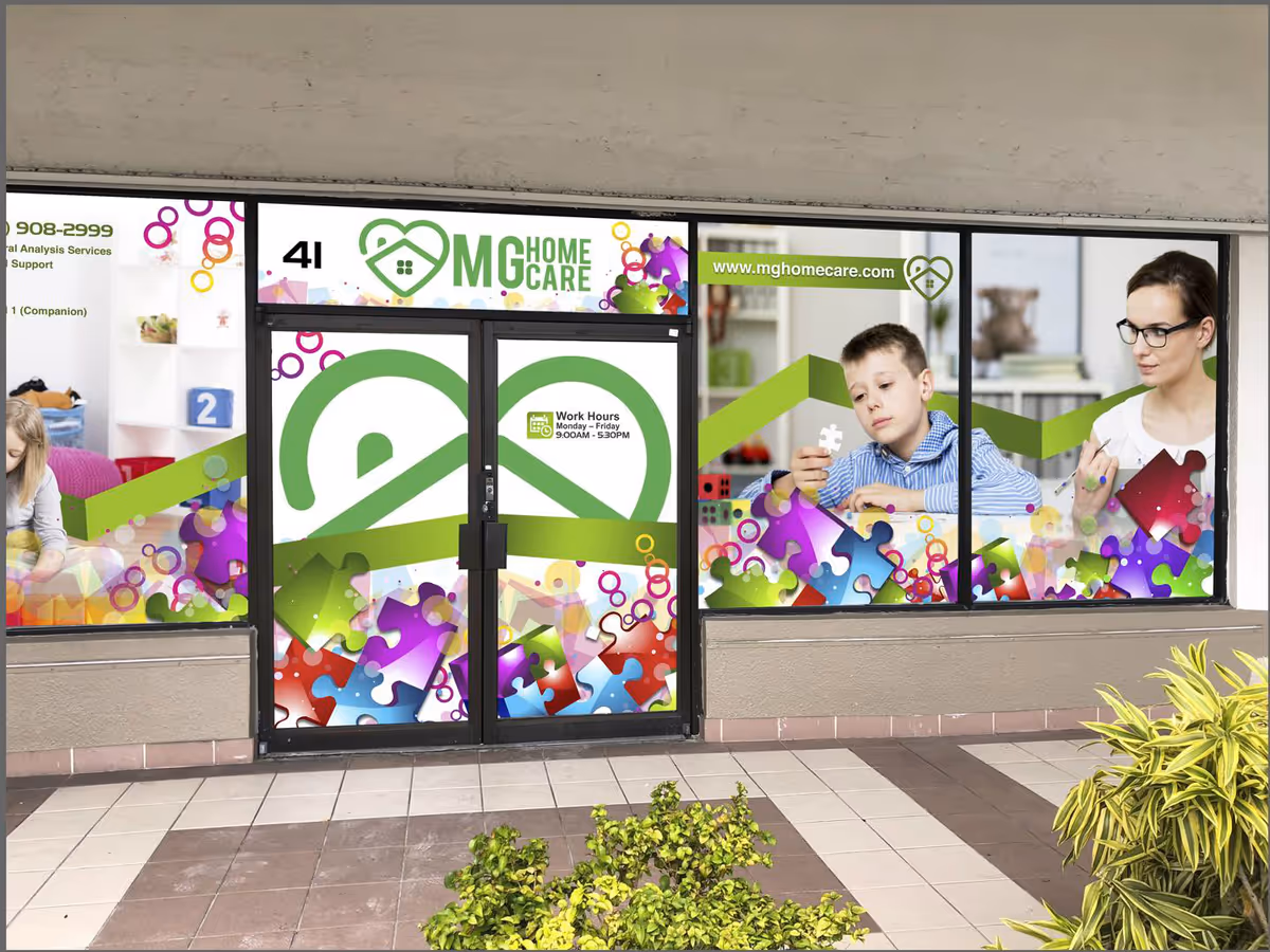 Colorful storefront windows and door with MG Home Care branding outside.