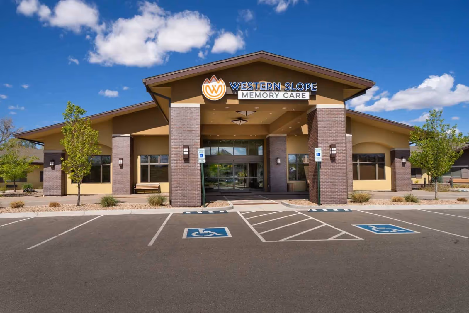 Front view of Western Slope Memory Care building with parking and handicap spaces
