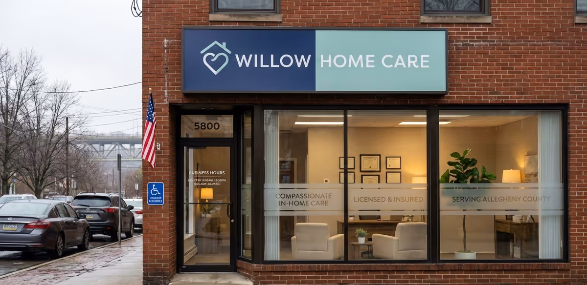 Brick storefront with Willow Home Care sign and large front windows showing a furnished lobby.