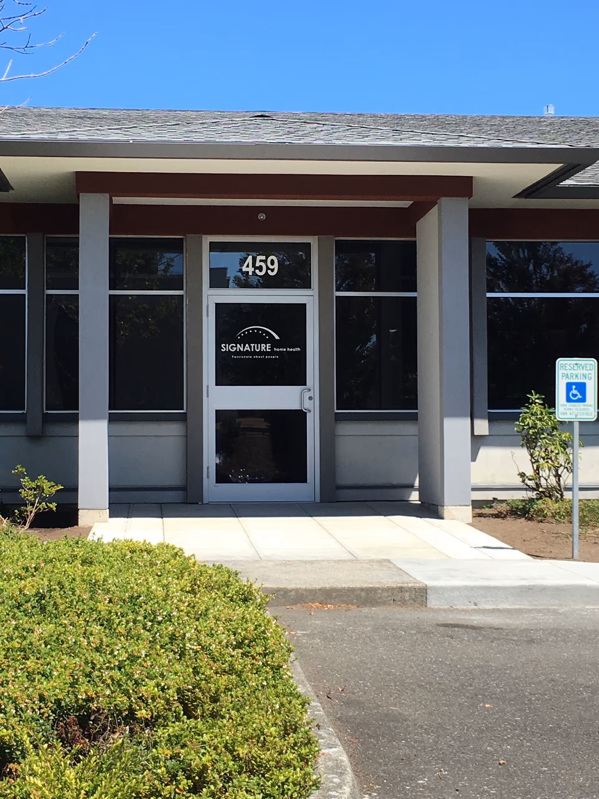 Front entrance of a facility with 459 address and Signature Home Health sign on the door