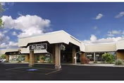 Exterior view of Good Samaritan Health Care Center entrance with parking and blue sky.