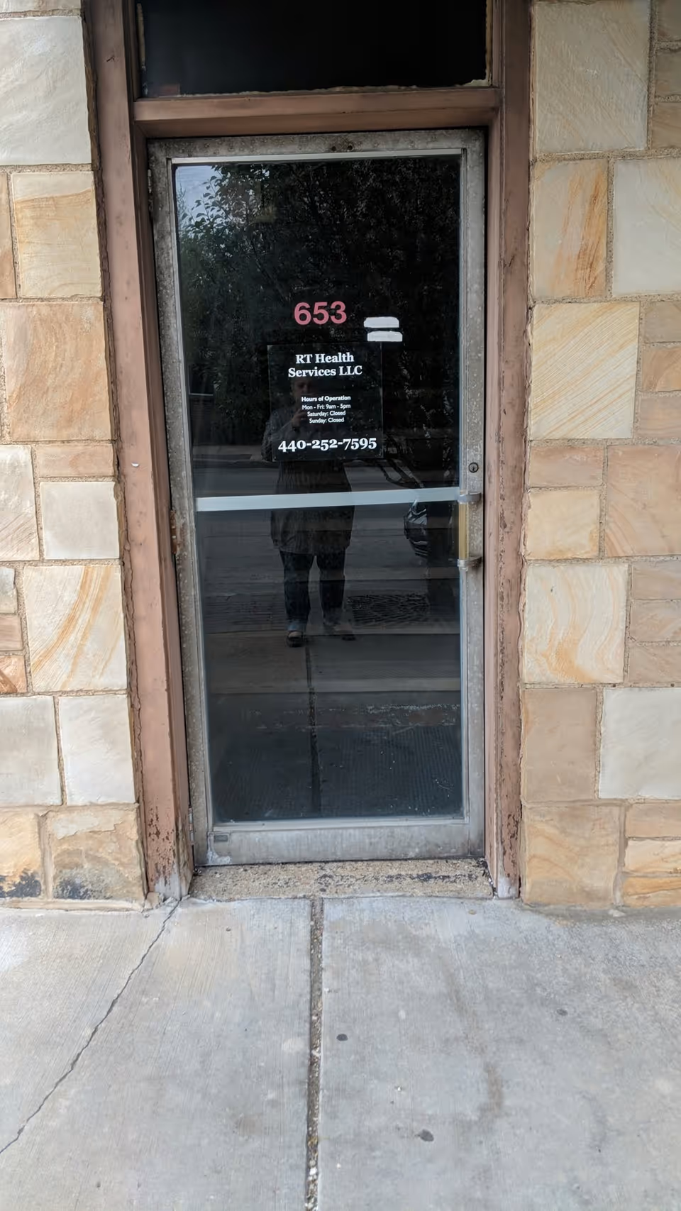 Stone exterior with a glass door labeled RT Health Services LLC at 653.