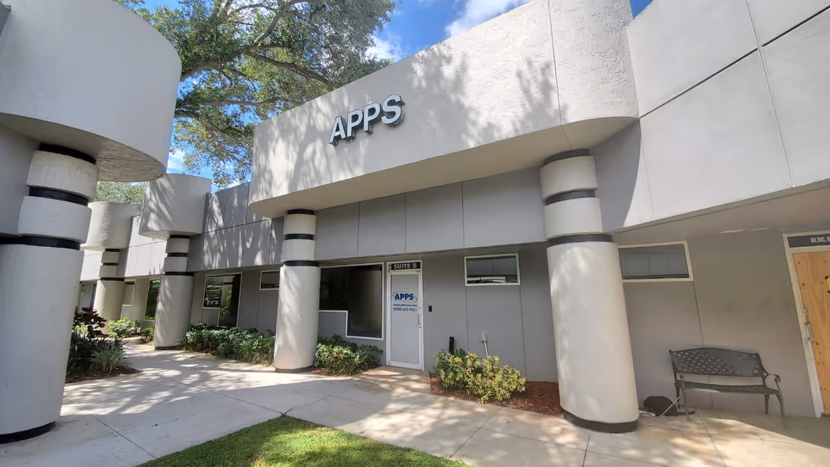 Exterior of APPS Paramedical Pembroke Pines building with columns, entrance door, and bench.
