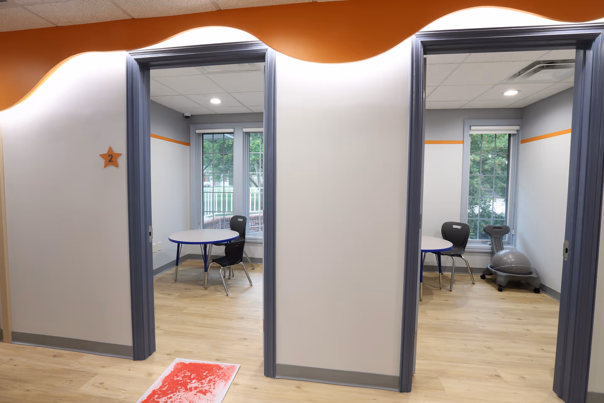 Two small interior rooms with round tables, chairs, and exercise equipment visible.