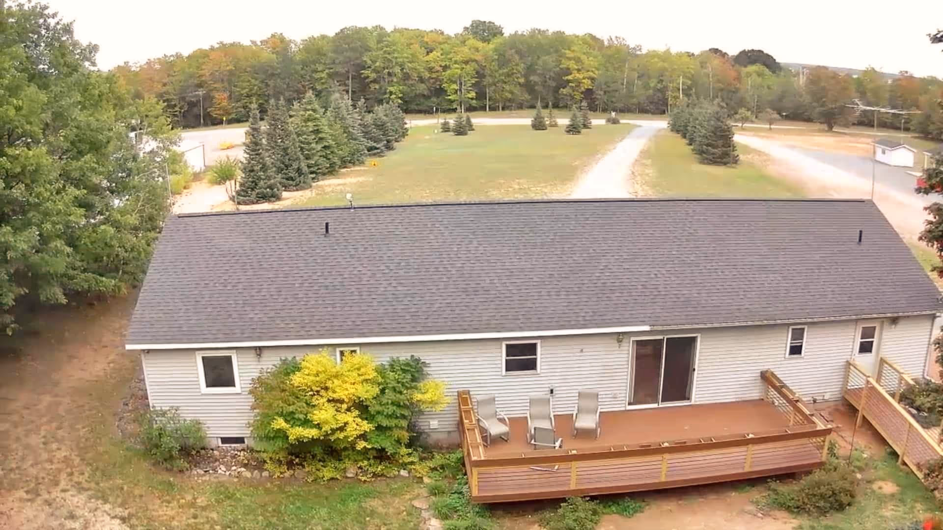 Exterior view of a single-story facility with a wooden deck and outdoor seating.