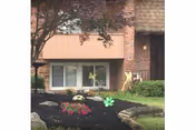 Exterior view of Williamstowne Senior Apartments front with brick facade and landscaped garden.