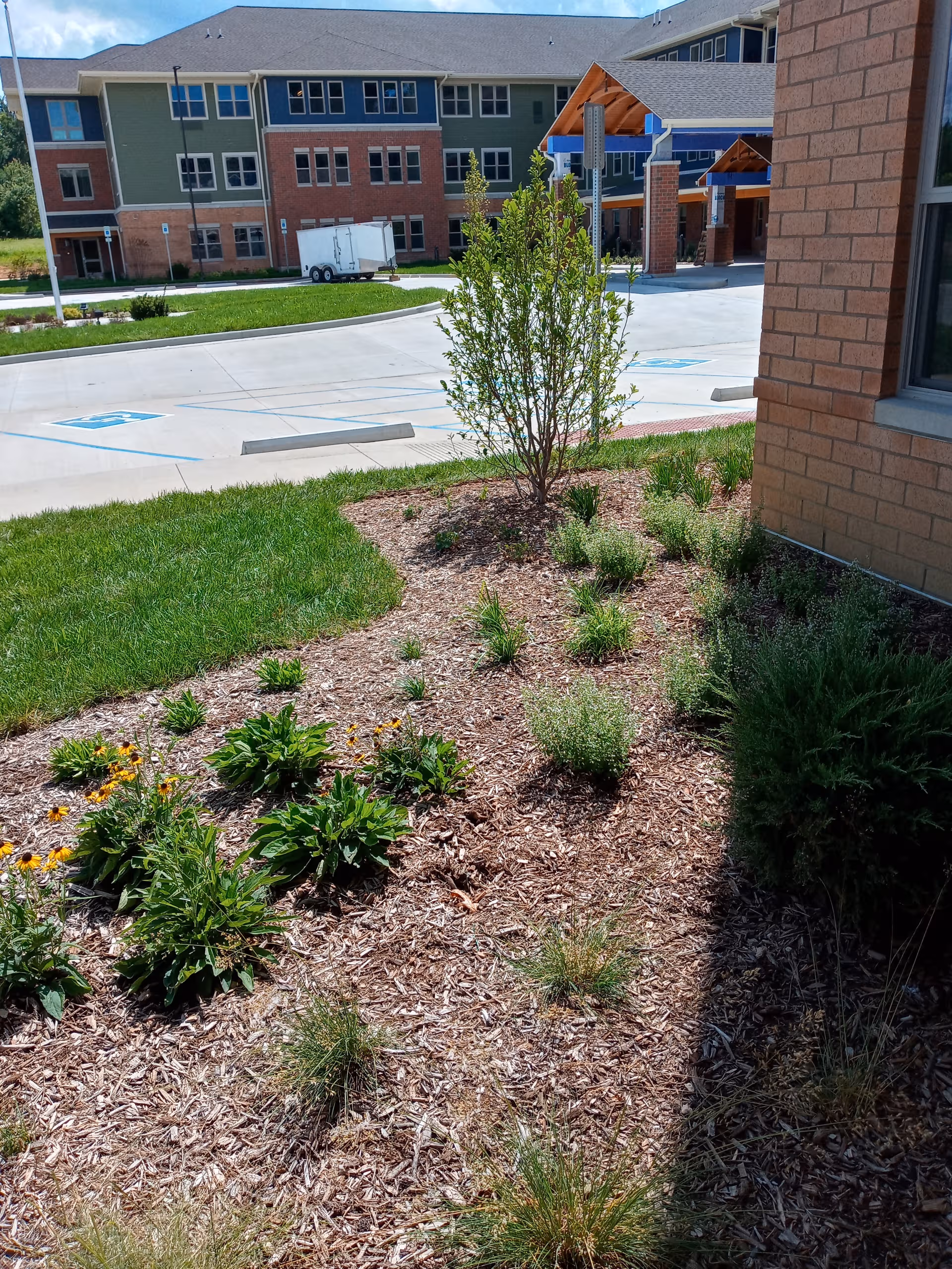 Exterior view of Heritage Woods of Newburgh with landscaped foreground and entrance canopy.