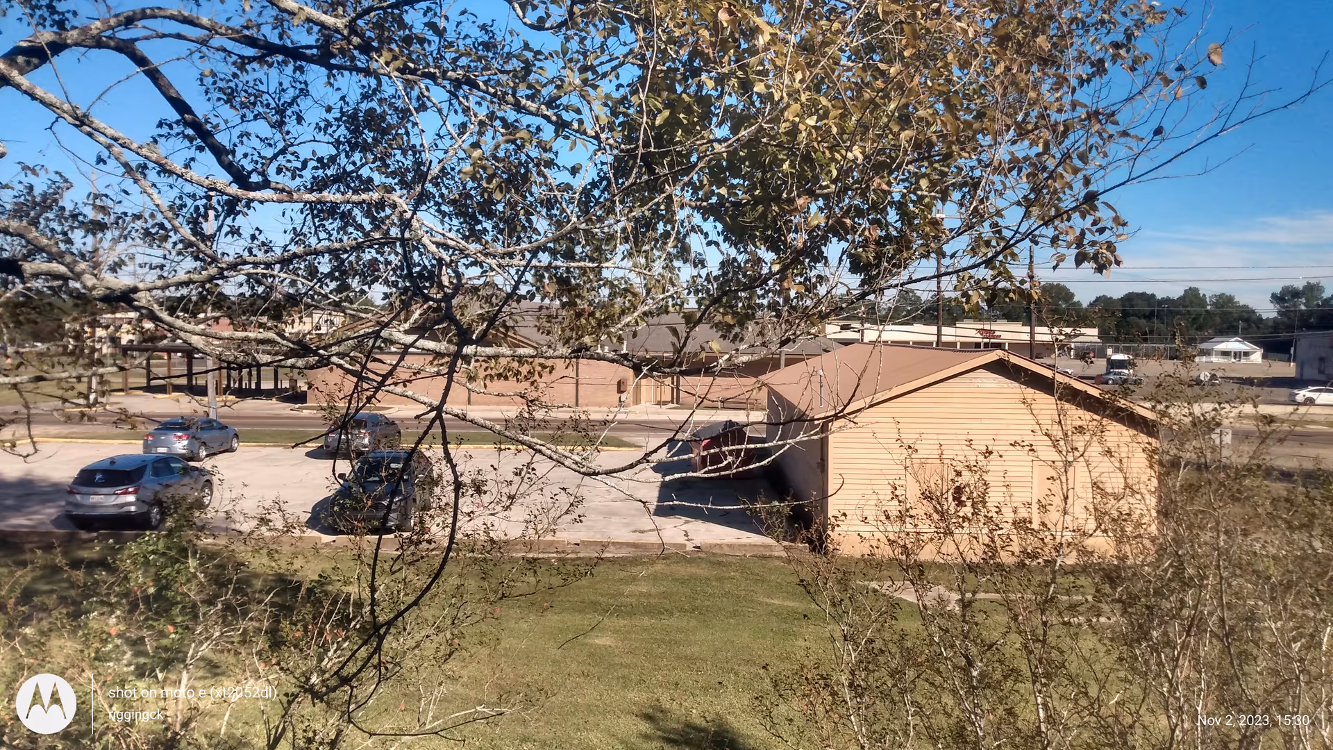 Exterior view of The Egan House with parked cars and trees in foreground