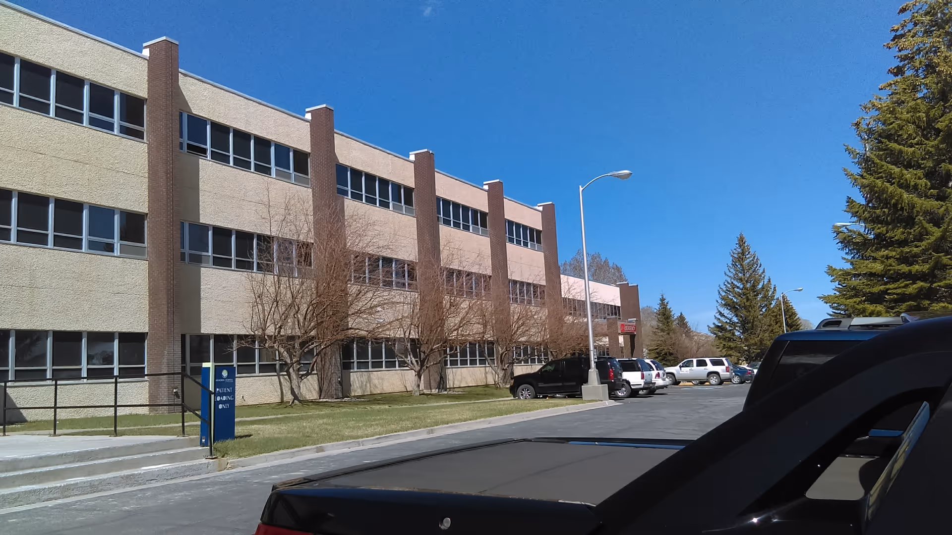 Exterior view of Memorial Hospital of Carbon County with a parking lot.