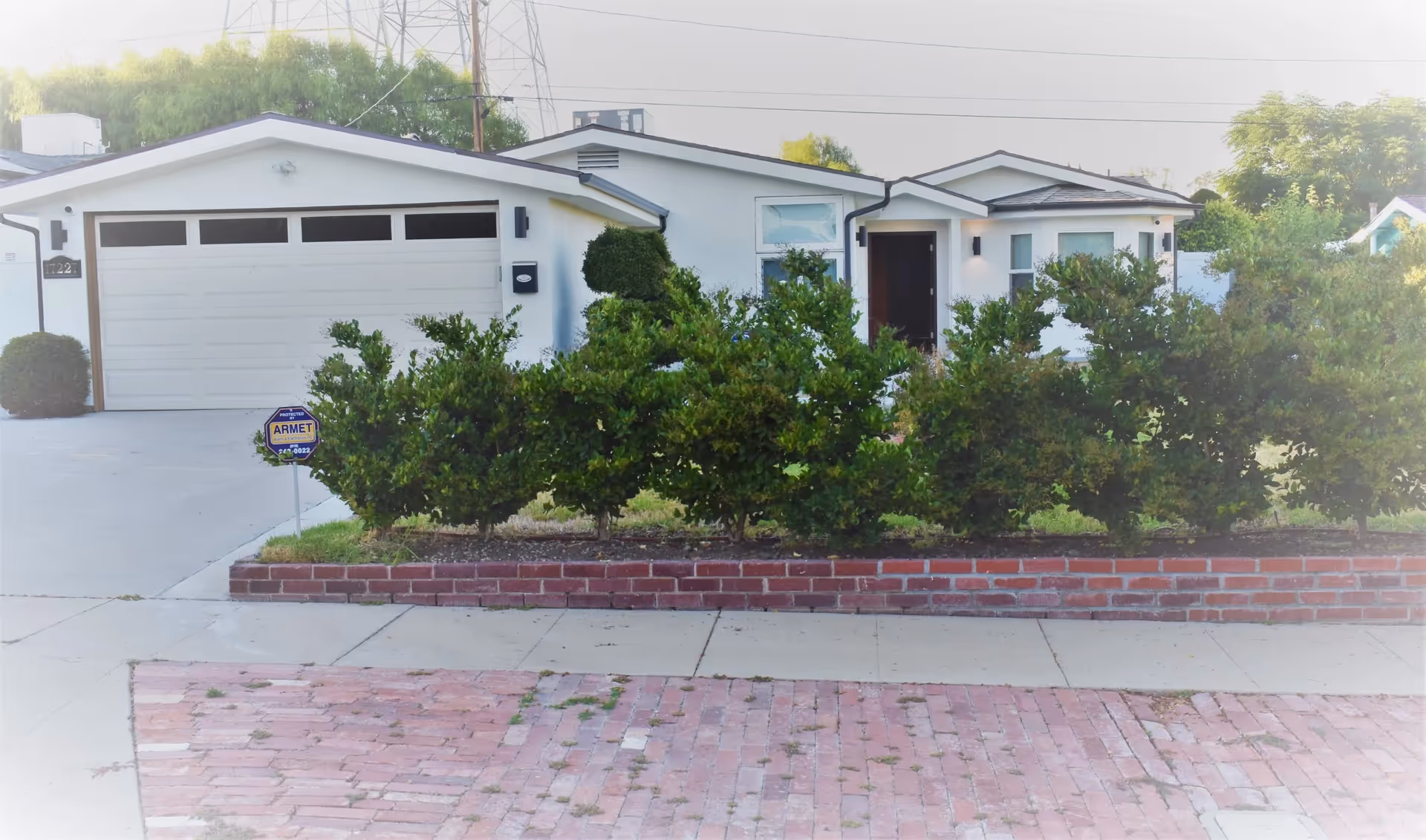 Single-story facility with a two-car garage, front entrance, and trimmed shrubs.