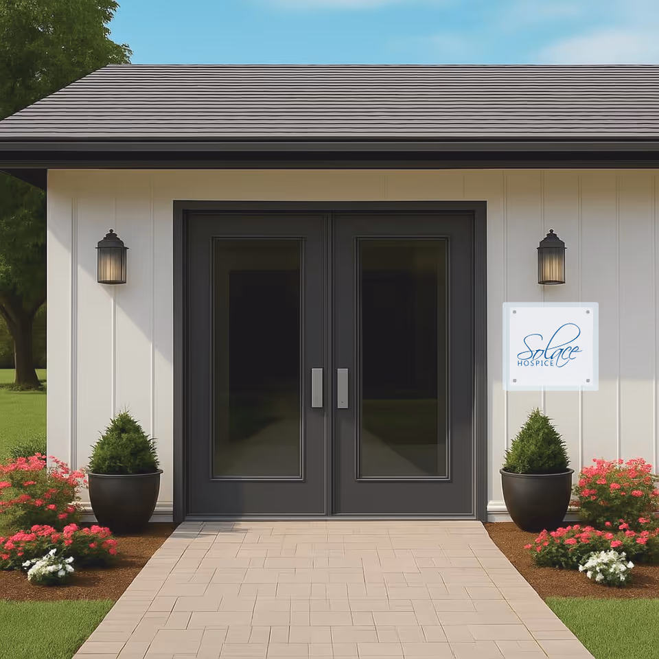 Front entrance of Solace Hospice with double doors, sign, and potted plants.