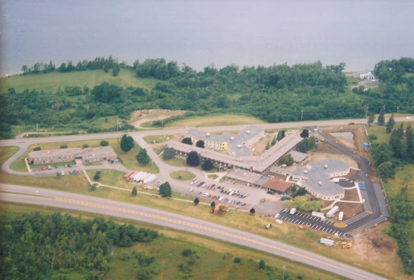 Aerial view of RiverLedge Nursing Home campus with buildings, parking, and green surroundings.