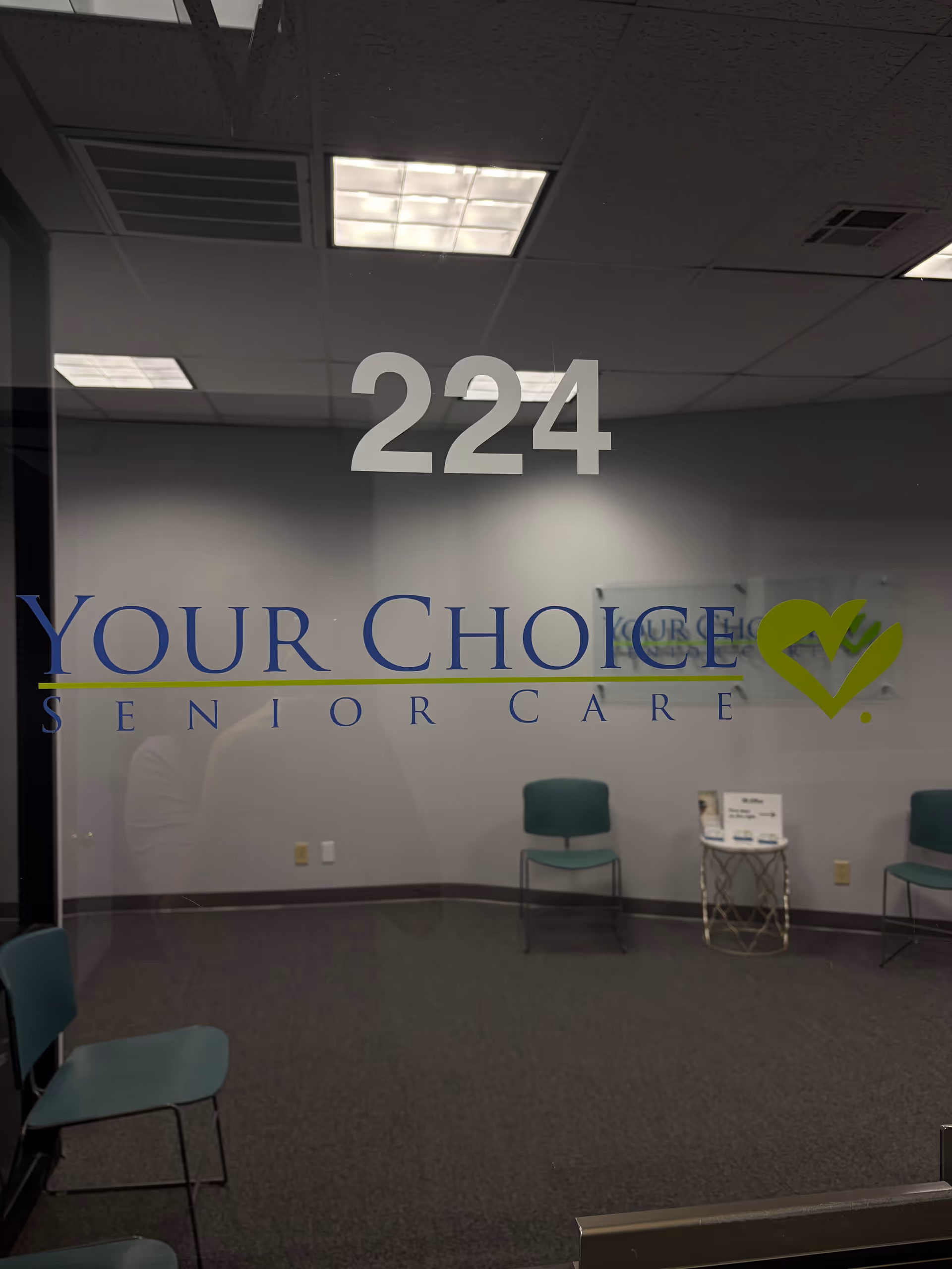 Lobby area with glass wall reading Your Choice Senior Care and seating.