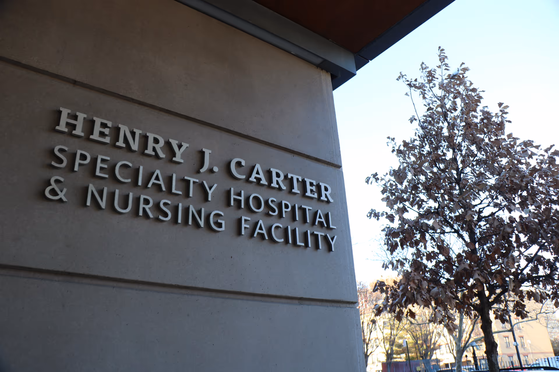 Exterior view of the Henry J. Carter facility sign on the building wall.