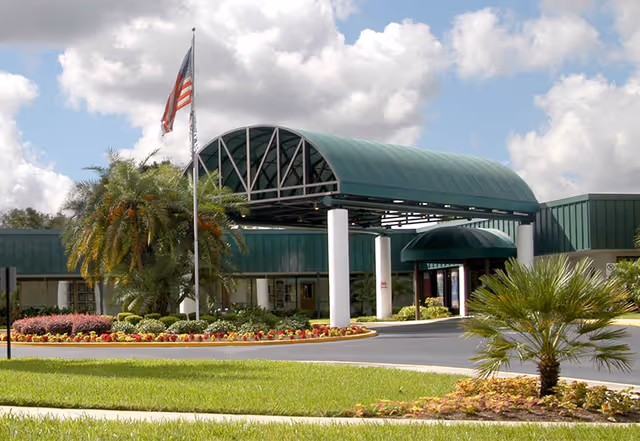 Front exterior view of AdventHealth Dade City with green entrance canopy and landscaping.