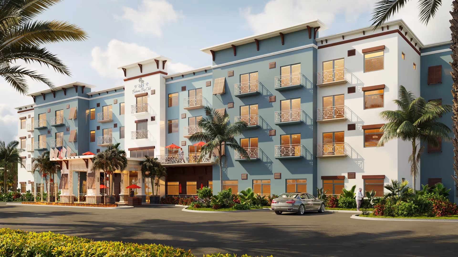 Exterior view of Bahama Bay Club Luxury Senior Living building with balconies and palm trees