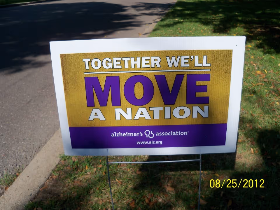 Outdoor lawn sign reading 'TOGETHER WE'LL MOVE A NATION' for Alzheimer's Association.
