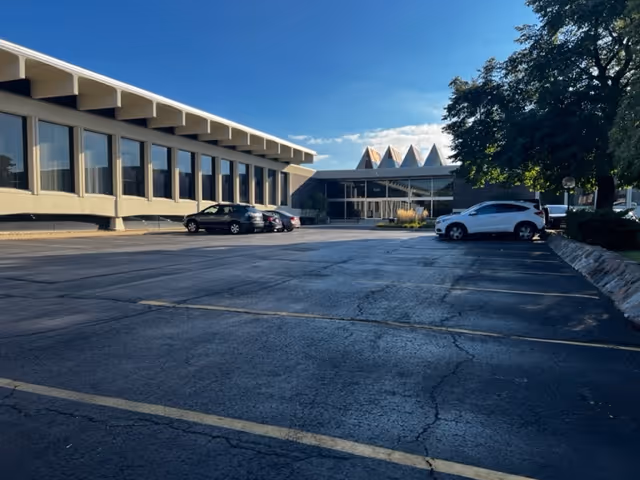Exterior view of Prime Senior Home Care facility with parking lot and entrance.