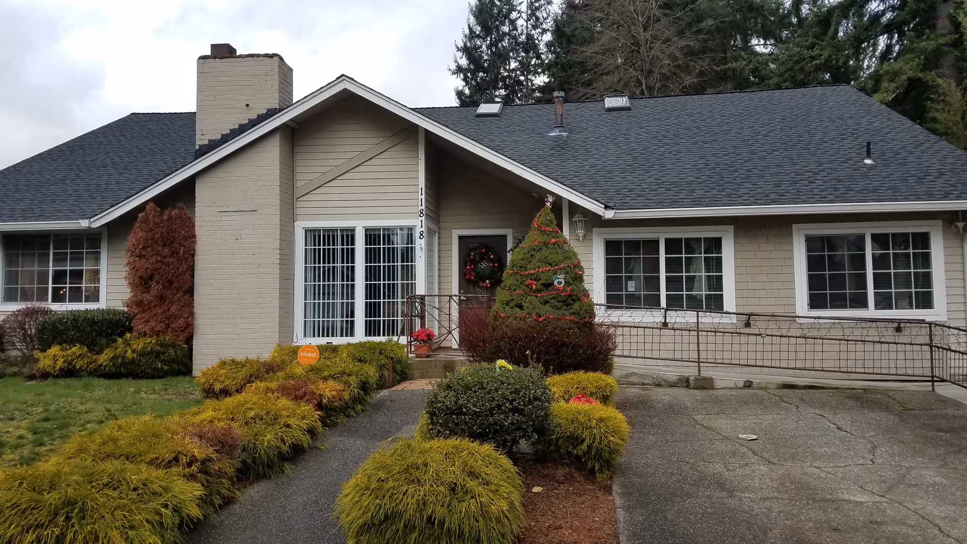 Front exterior of Sunshine Park AFL Home Care building with wreath and shrubs