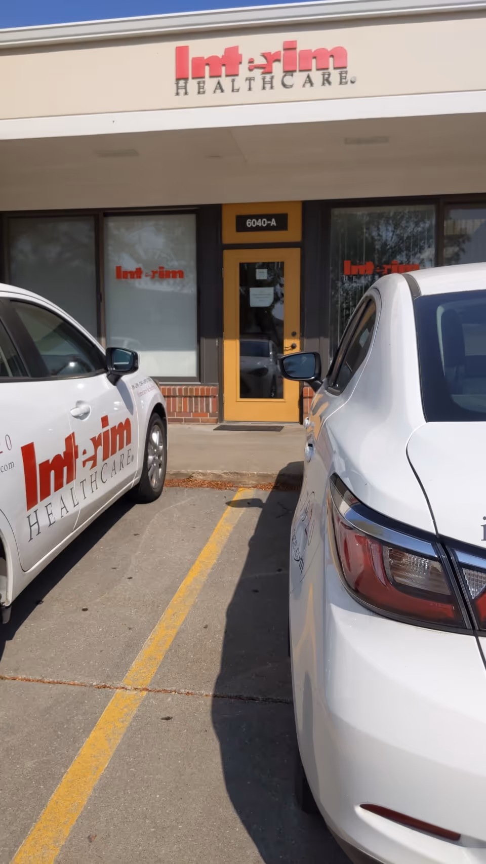 Exterior view of Interim HealthCare of Lincoln facility with parked cars.