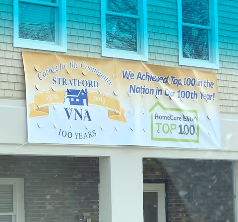 Exterior view of Stratford VNA building with a celebratory banner.