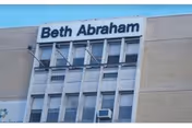 Exterior view of a multi-story building with a Beth Abraham sign on the facade