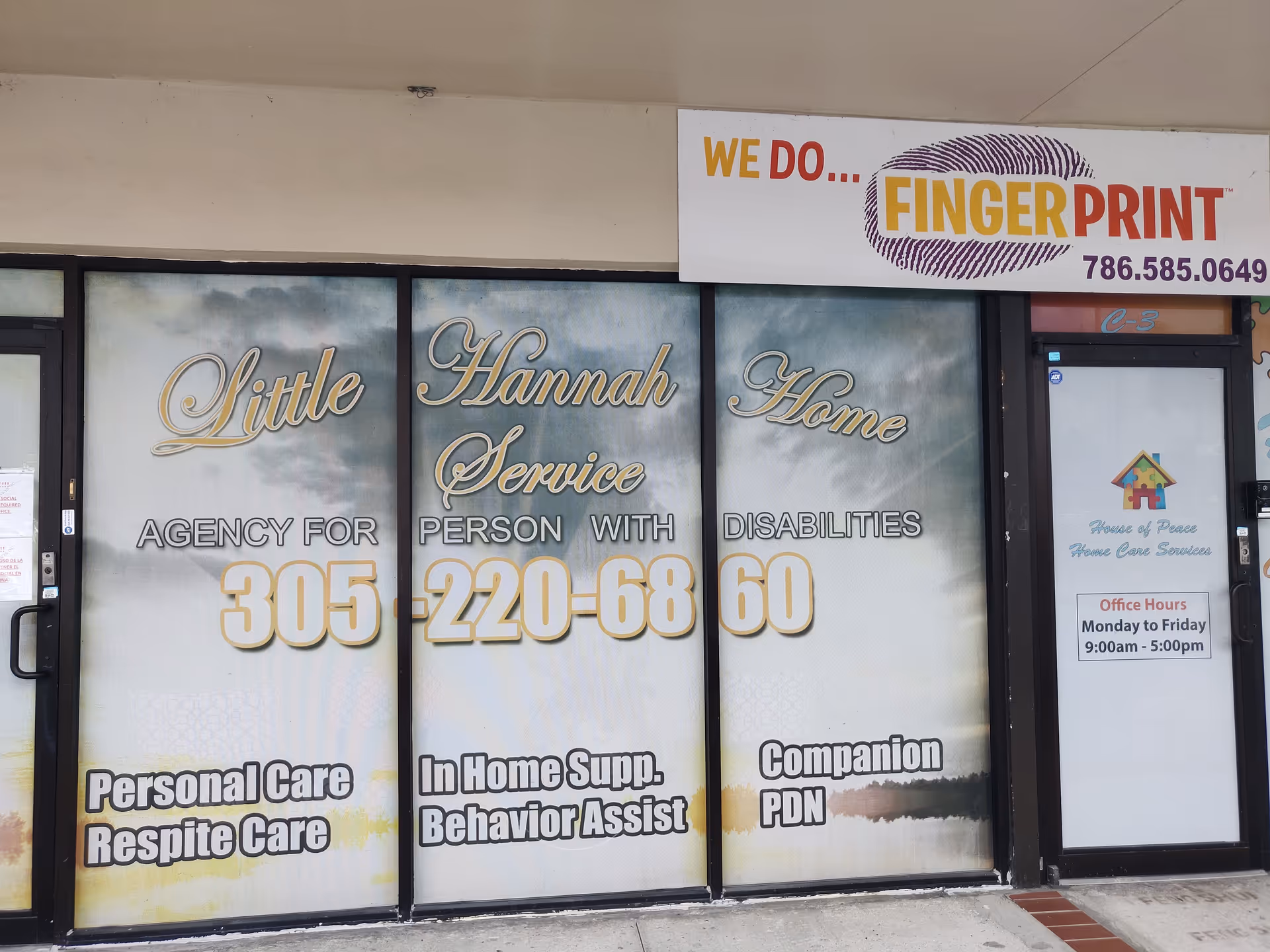 Exterior storefront with large glass windows advertising Little Hannah Home Service and care offerings.