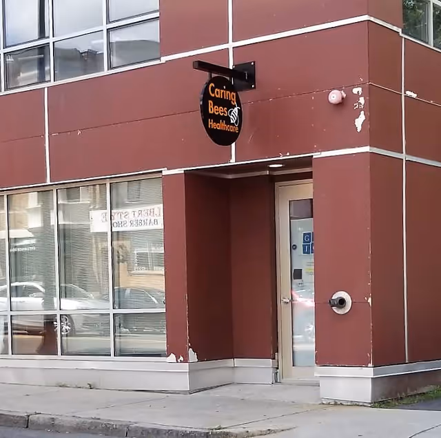 Exterior view of Caring Bees Healthcare building with glass windows and entrance door.
