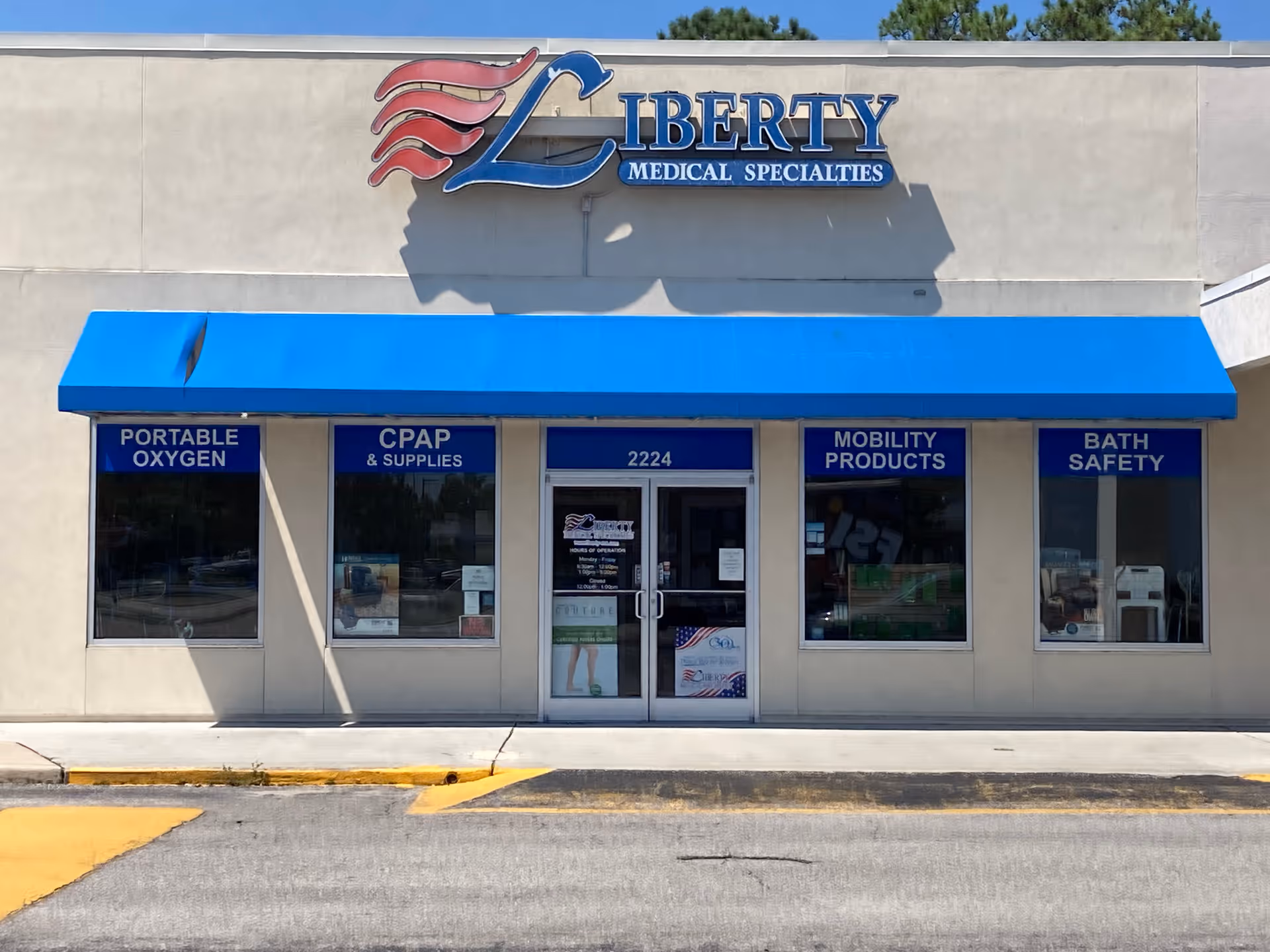 Storefront of Liberty Medical Specialties with blue awning and supply signs.